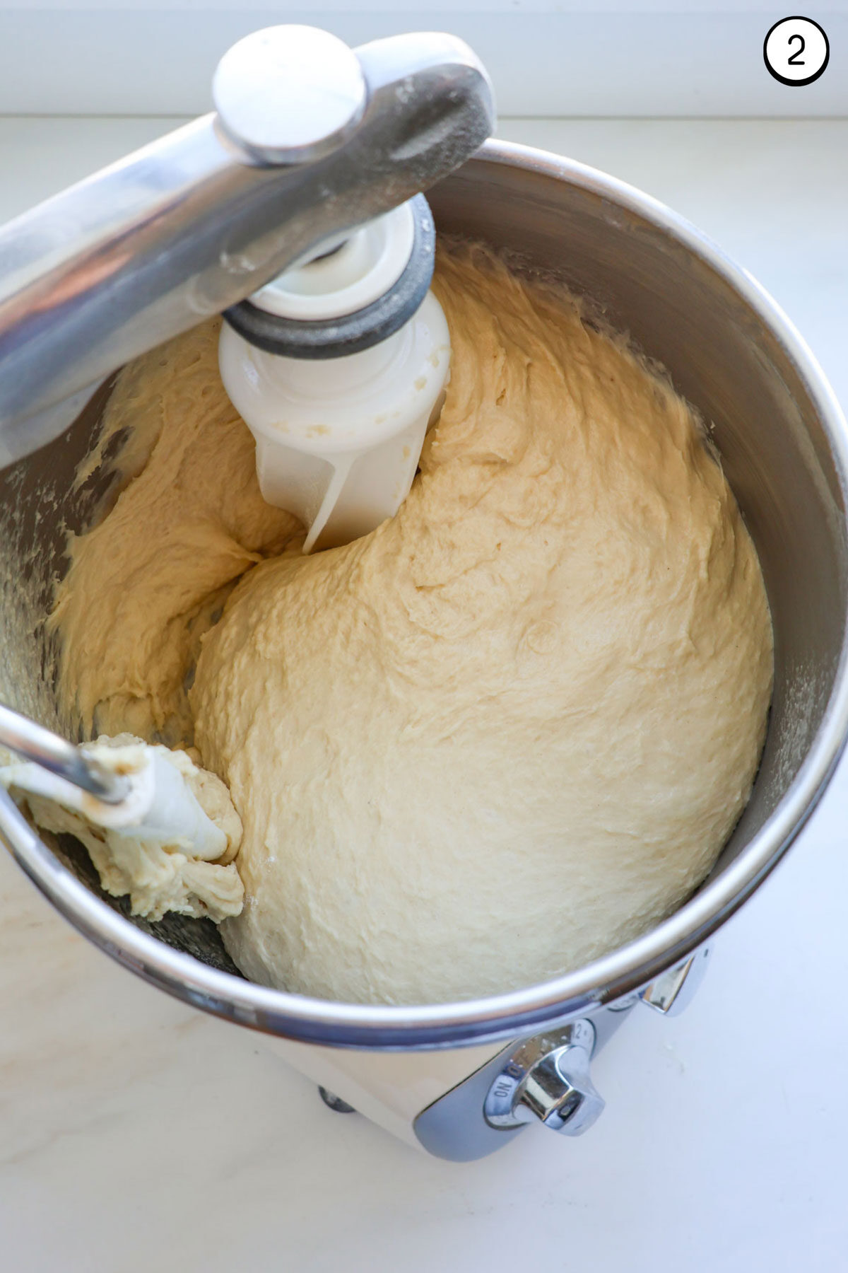 Mixed crescent roll dough in a stand mixer.