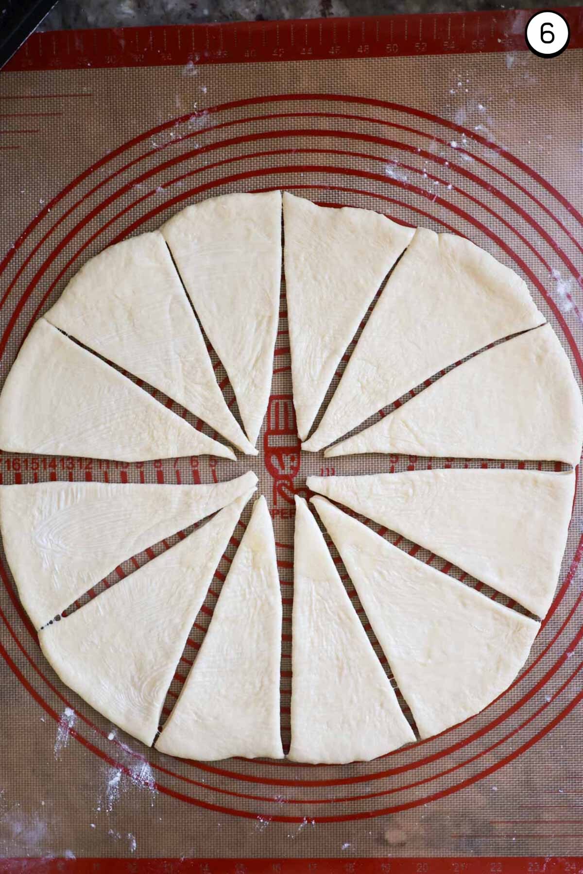 Crescent roll dough rolled out to a circle, with 12 equal wedges cut.