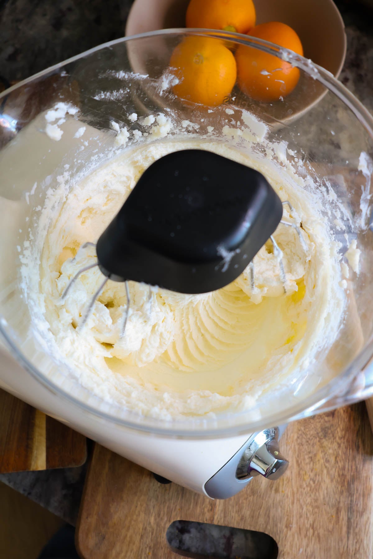 A mixer bowl, with butter, sugar and orange zest creamed together in a smooth mixture.