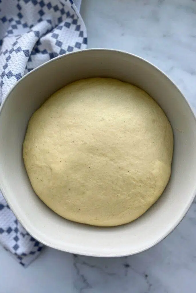 A bowl of cinnamon roll dough.
