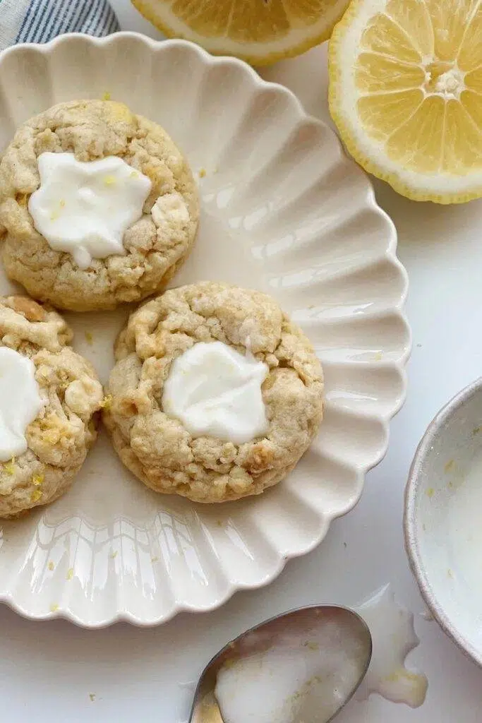 Three lemon cheesecake cookies, on a dessert plate.
