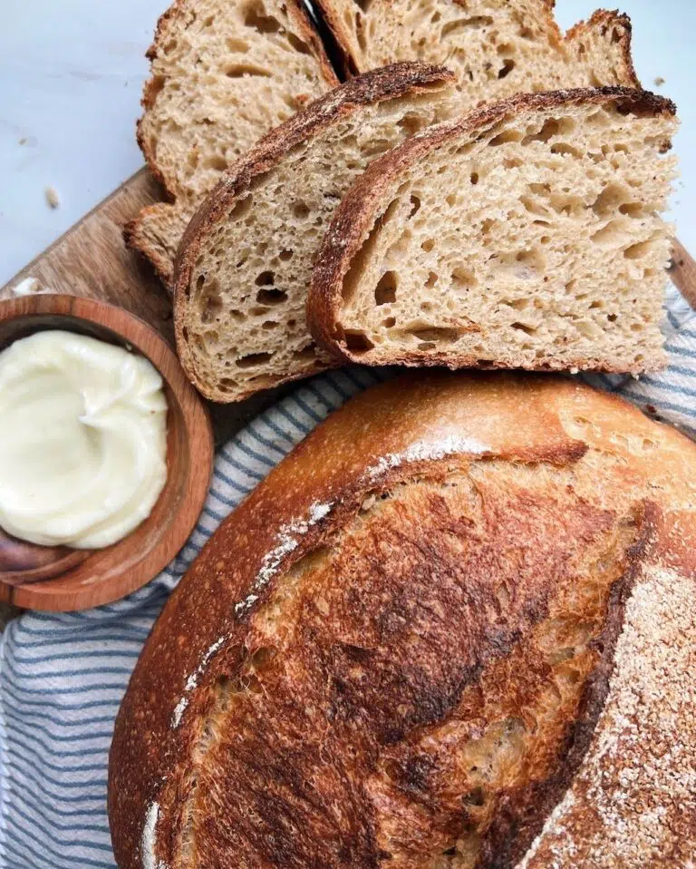 Whole grain bread sliced with butter on the side.