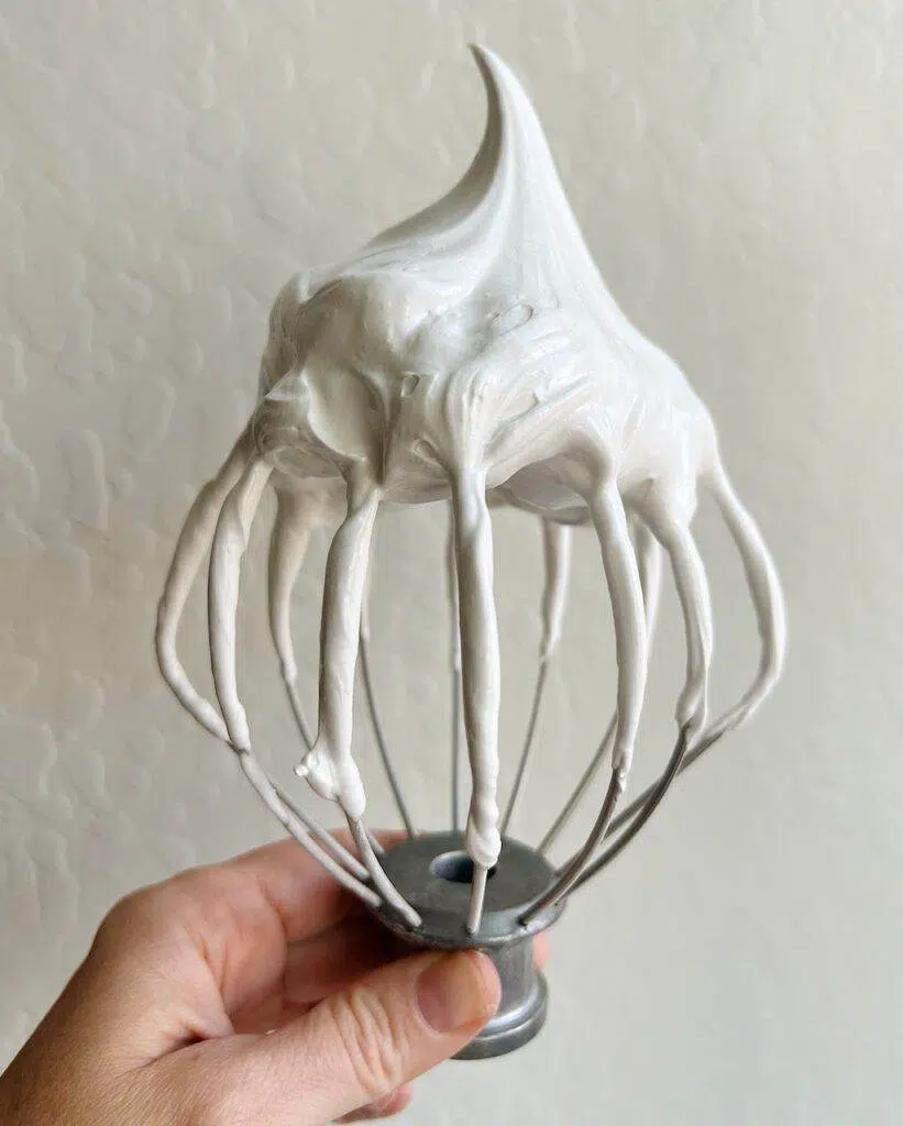 A Kitchen Aid whisk attachment with a stiff meringue mixture.
