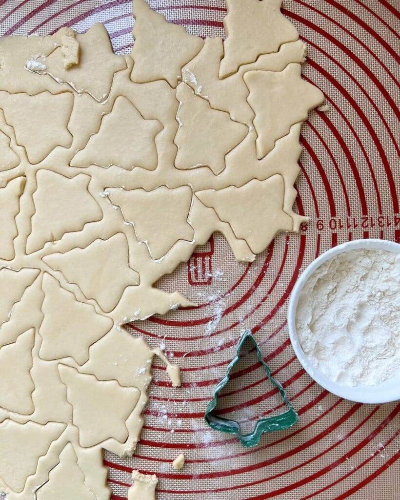 Christmas tree sugar cookie cutouts in dough.
