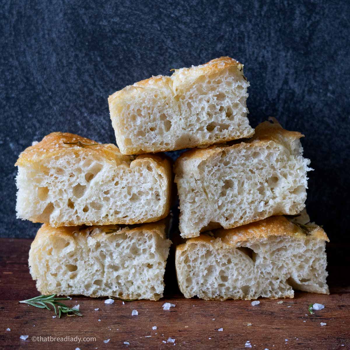 Slices of baked focaccia, stacked on top of each other.