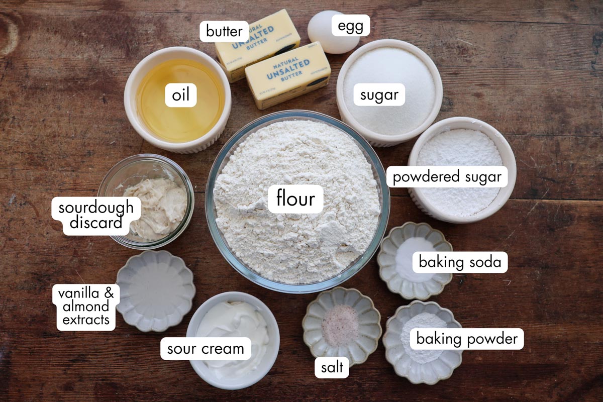 All the sourdough sugar cookie ingredients all measured out, on a wood table top.
