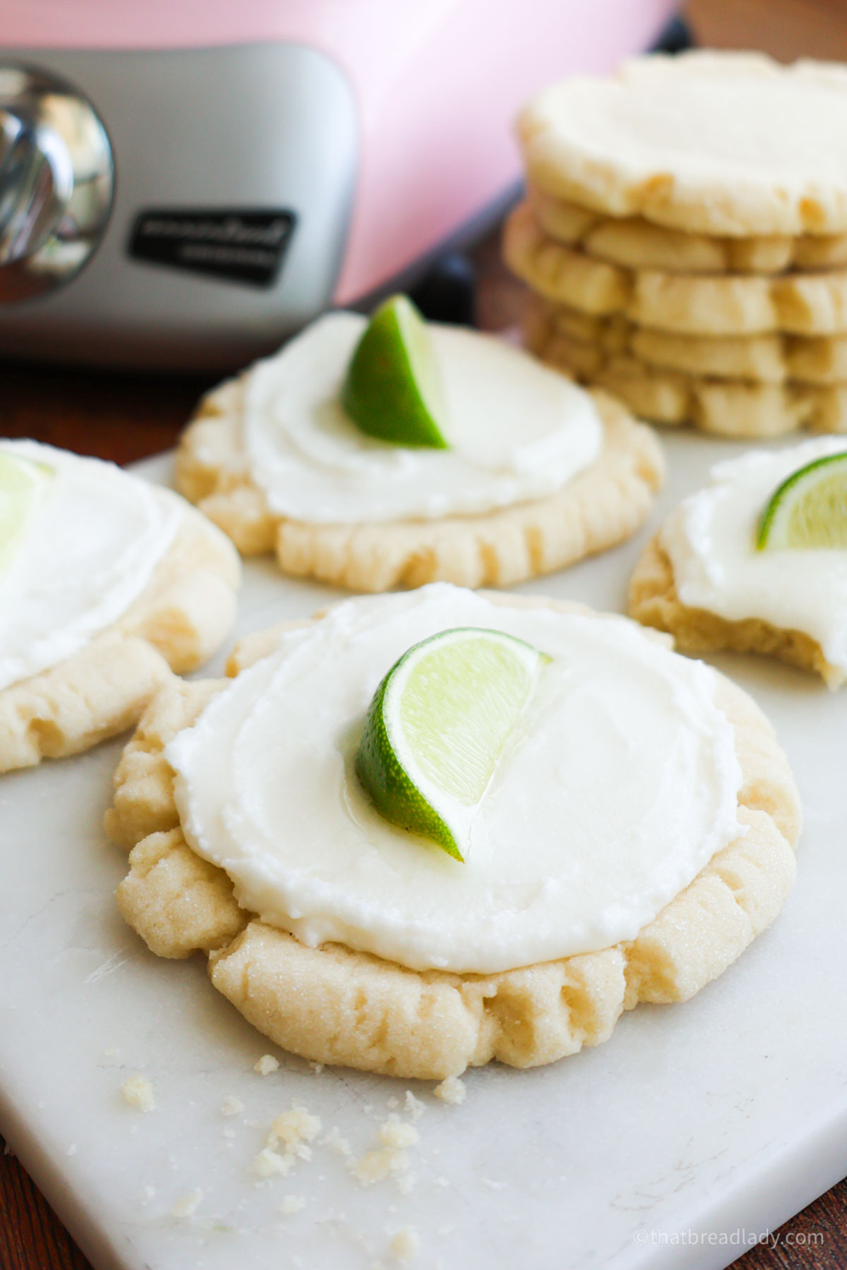 Coconut Lime sugar cookies with a lime wedge on top.