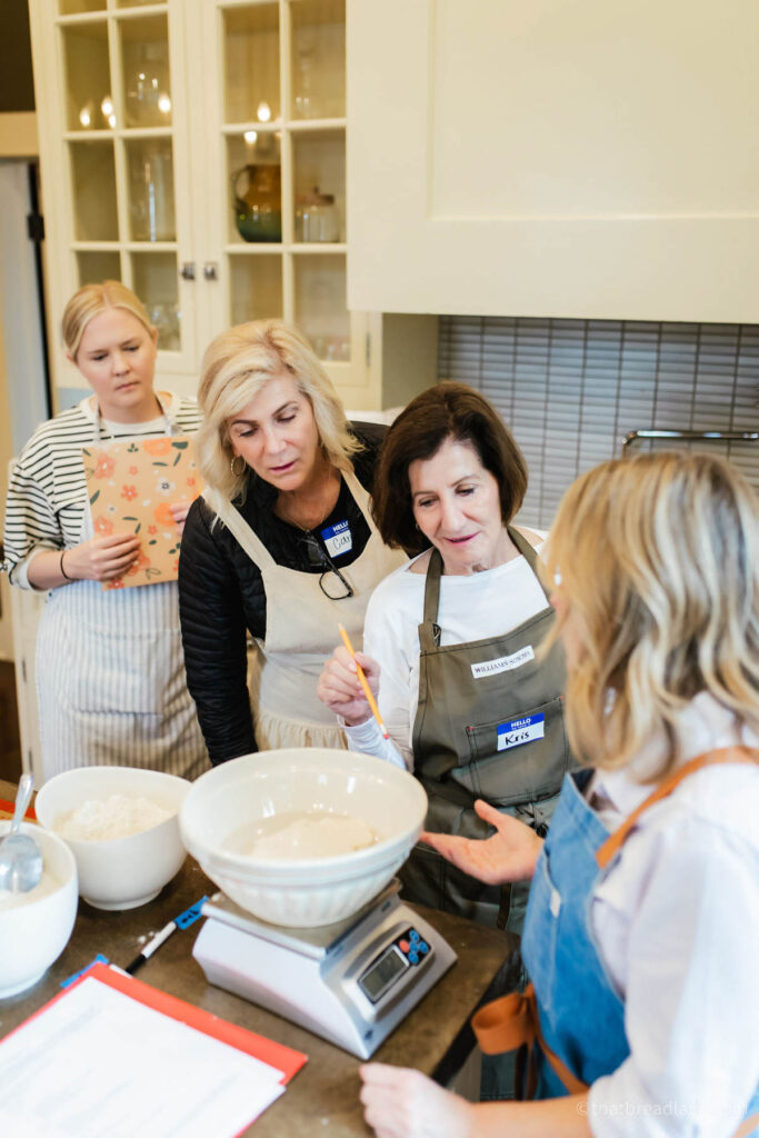 Heather with some women from her baking retreat, in the kitchen making bread.