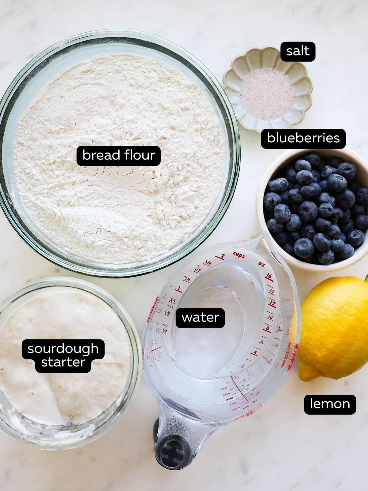 Ingredients for lemon blueberry sourdough all measured out and in their own bowls.