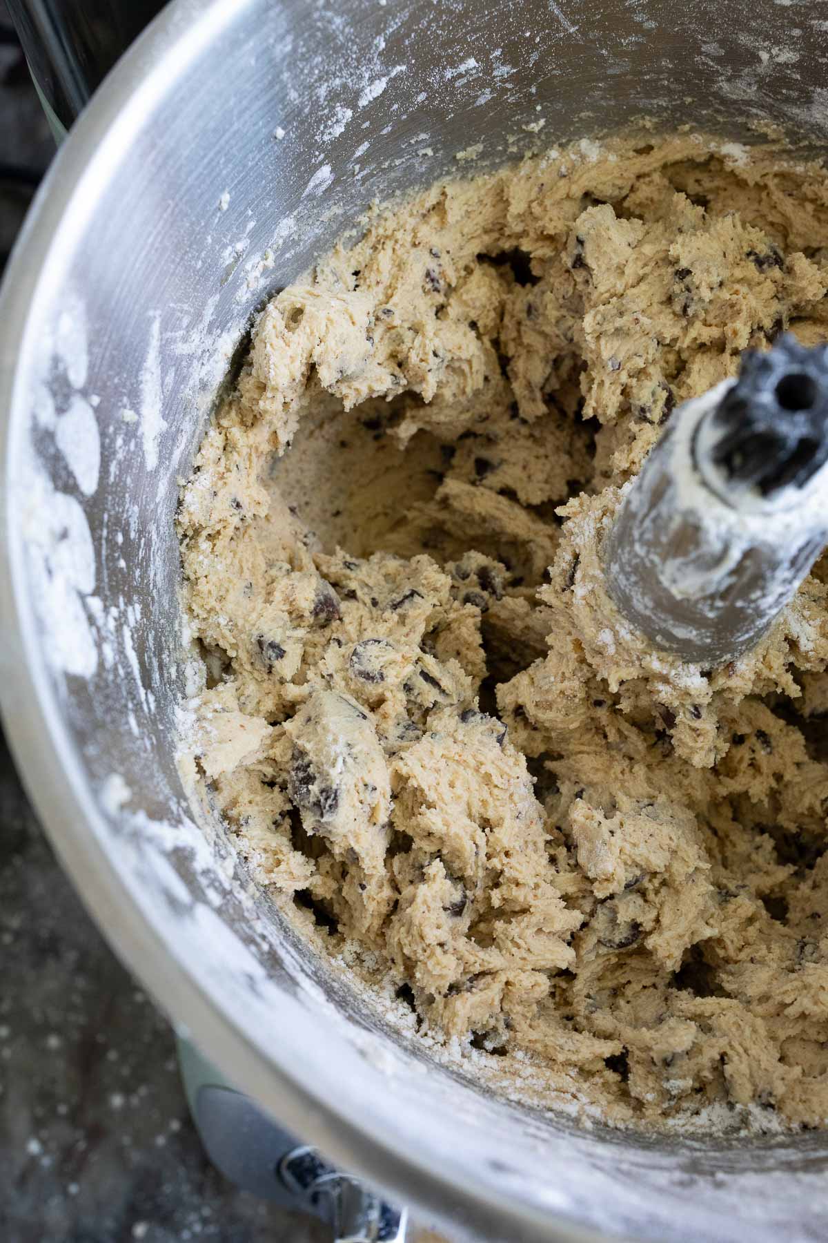 Brown butter sourdough chocolate chip cookie dough all mixed together in a mixer bowl.
