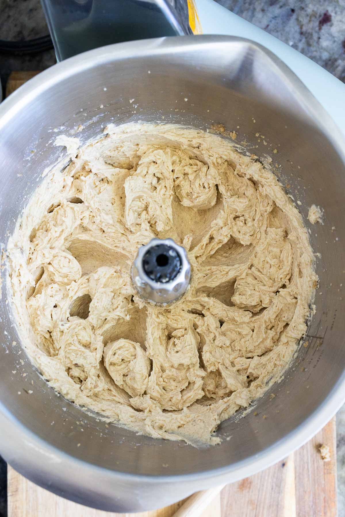 A creamed mixture of brown butter sourdough chocolate chip cookie dough in a mixer bowl.