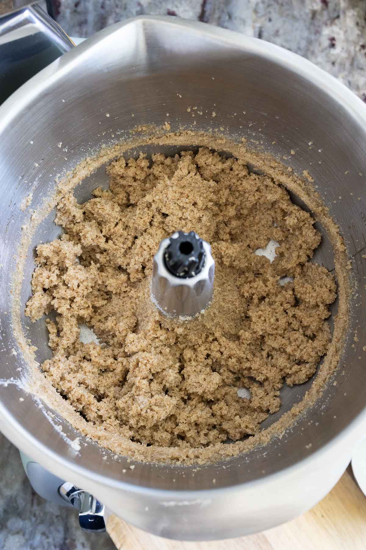 The sugars and butter for brown butter sourdough chocolate chip cookies, mixed together in a mixer bowl.
