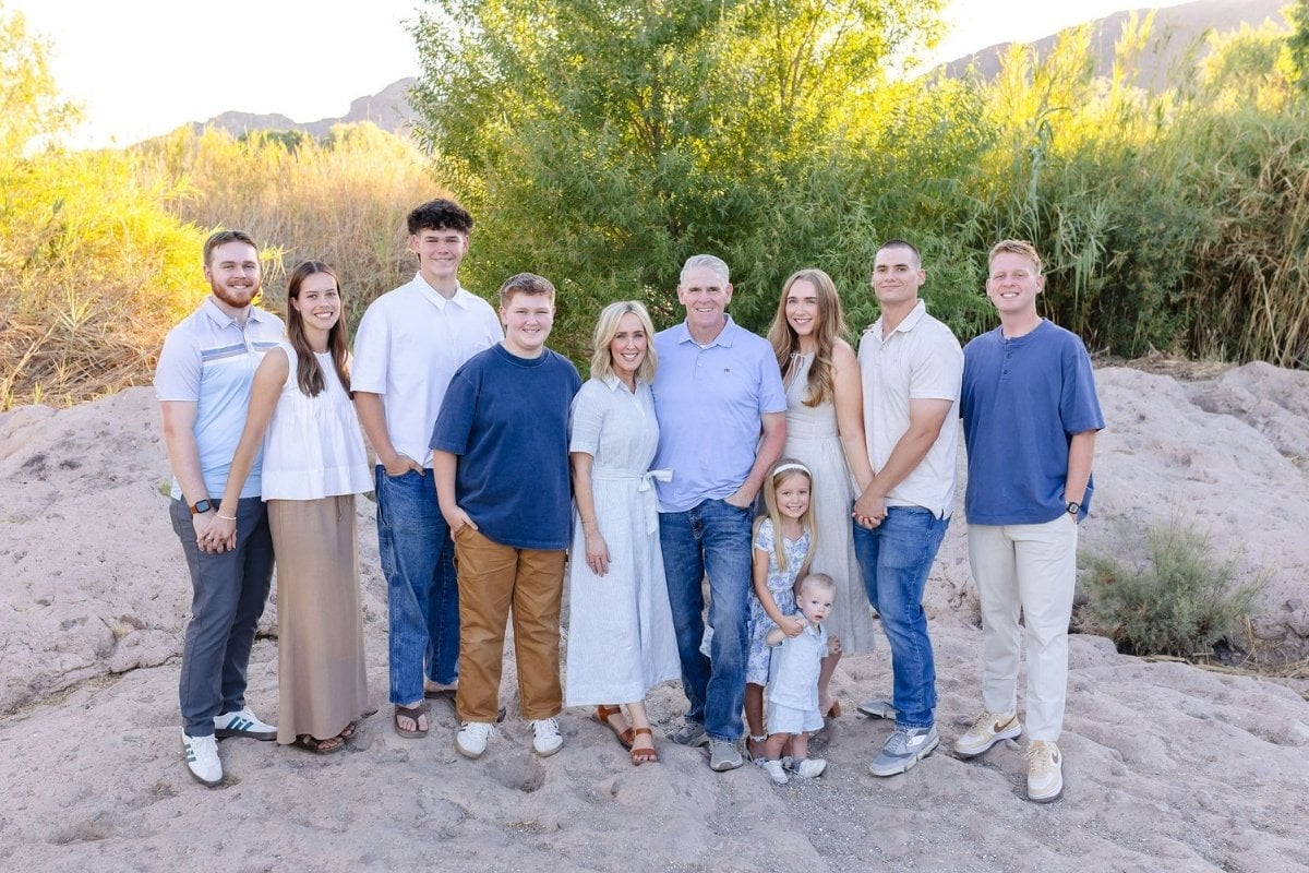Heather Thomas, creator of That Bread Lady, and her family, standing on a desert rock with trees and mountains.