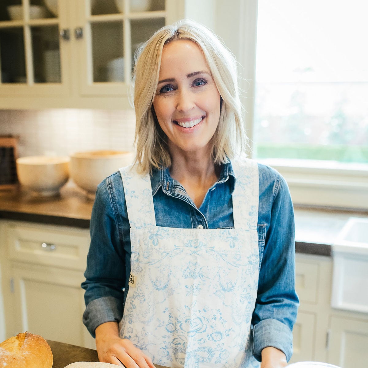 Heather Thomas, creator of That Bread Lady, standing in a kitchen.