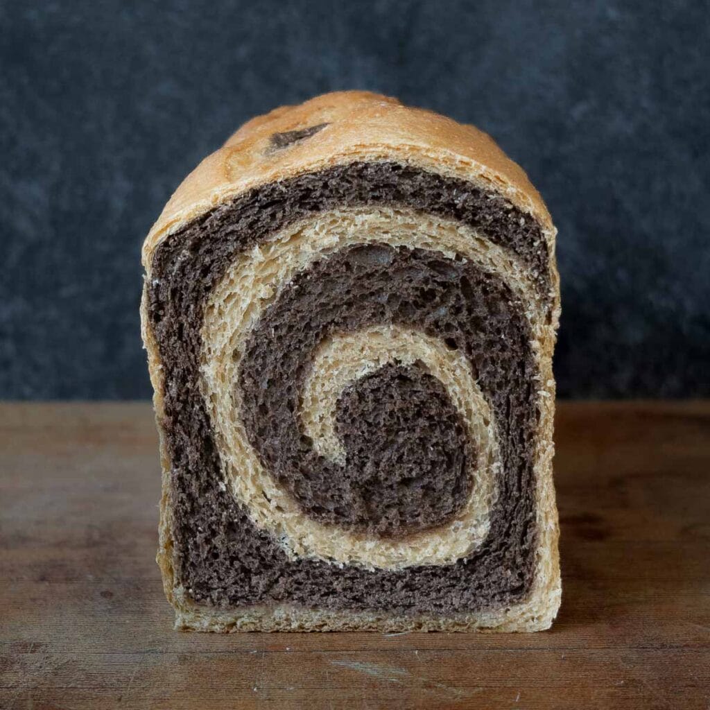 A sliced loaf of marble rye, showing the center of the loaf.