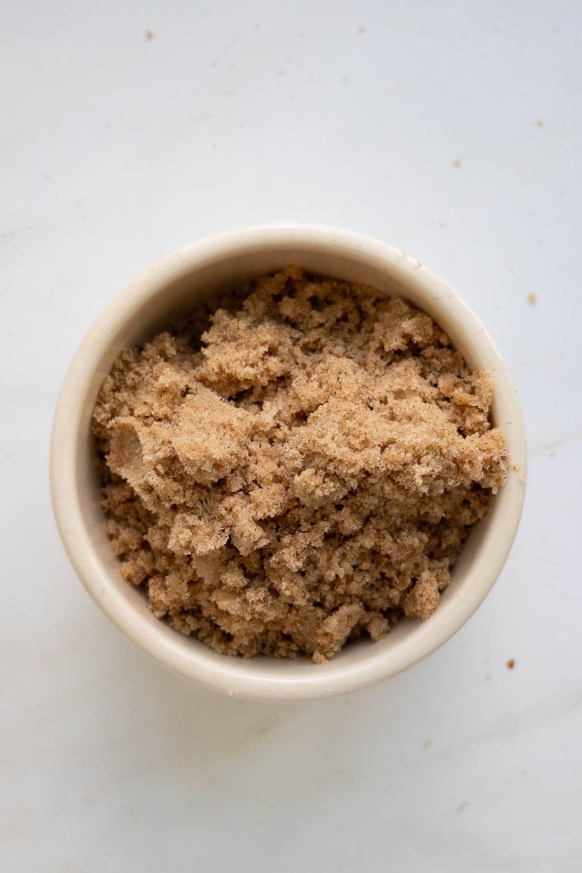 A bowl with a brown sugar crumb mixture.