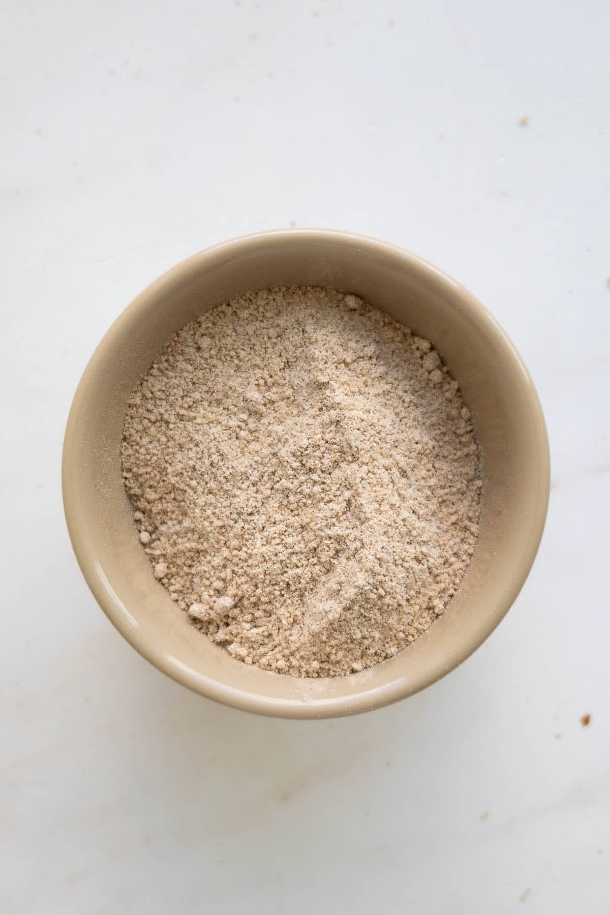 A bowl with a cinnamon and flour mixture.
